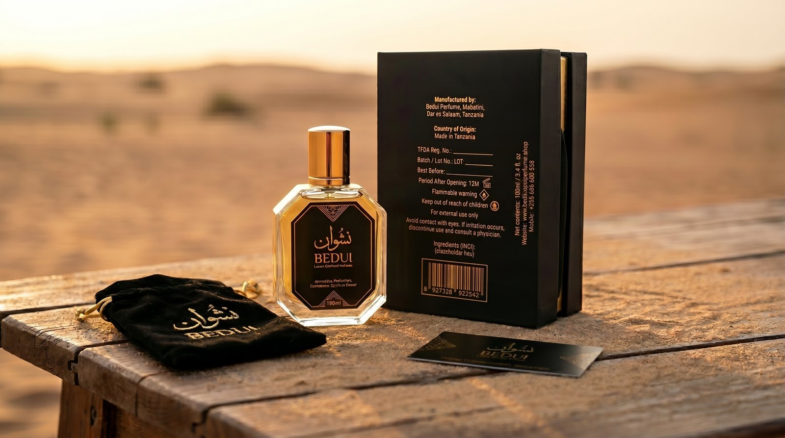 BEDUI NSHWAN complete gift set on wooden table in desert at sunset — bottle, box, velvet pouch and card